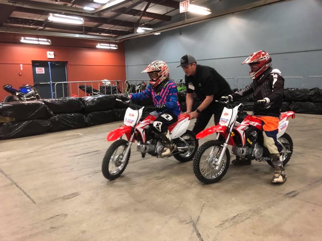 kids doing a dirt bike demo with a coach at the Moto Show