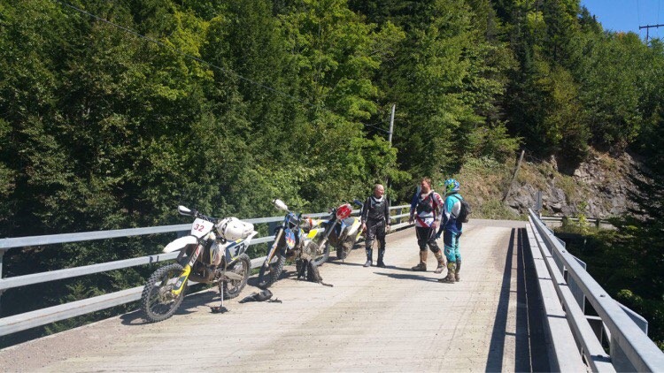 Dirt bike riders on a bridge