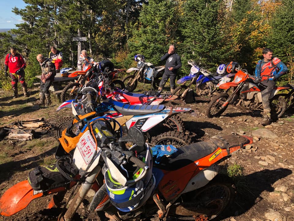 dirt bike riders gather in an opening on the trail