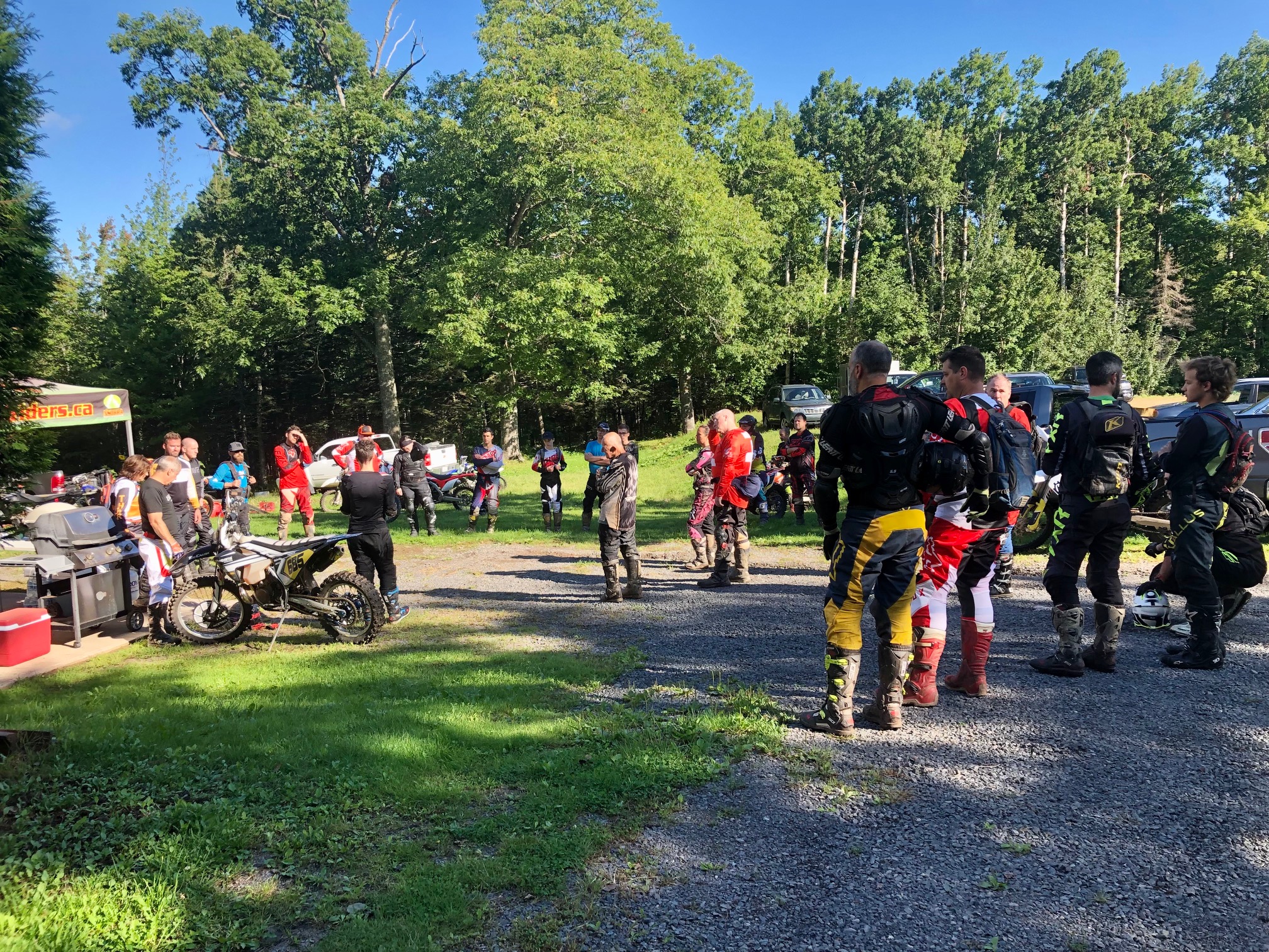 rec ride dirt bikers attend a riders meeting outside in an open space
