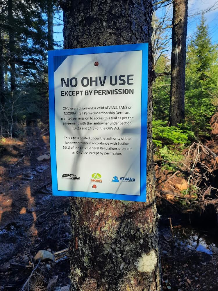 OHV restriction sign attached to a tree