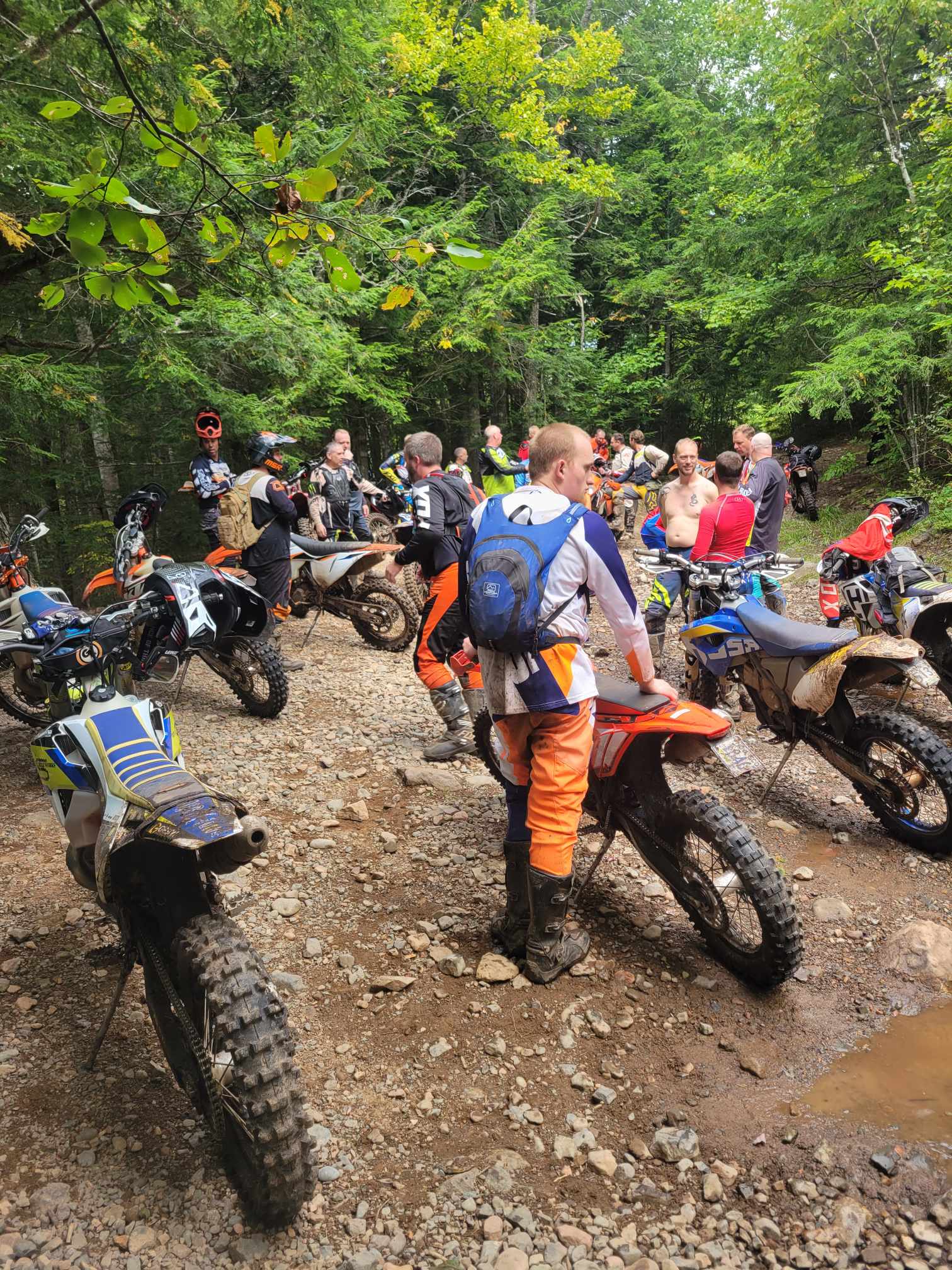 dirt bikers getting ready to head out on a trail