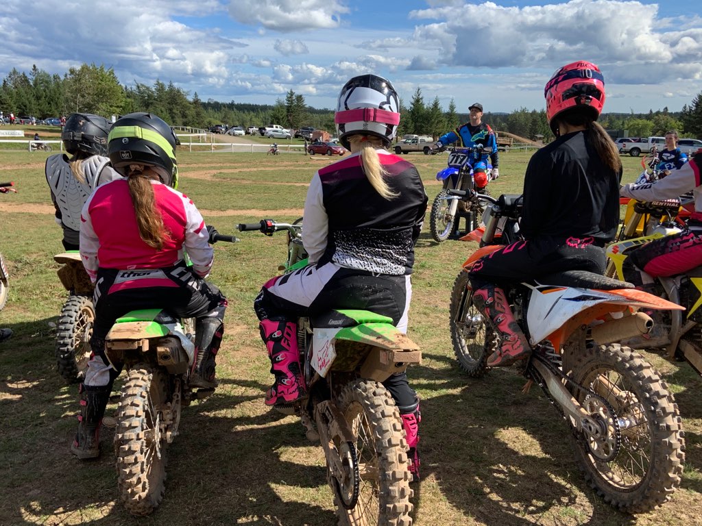 Women on dirt bikes getting instruction