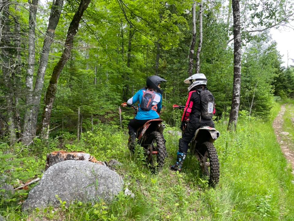 two female riders in the woods