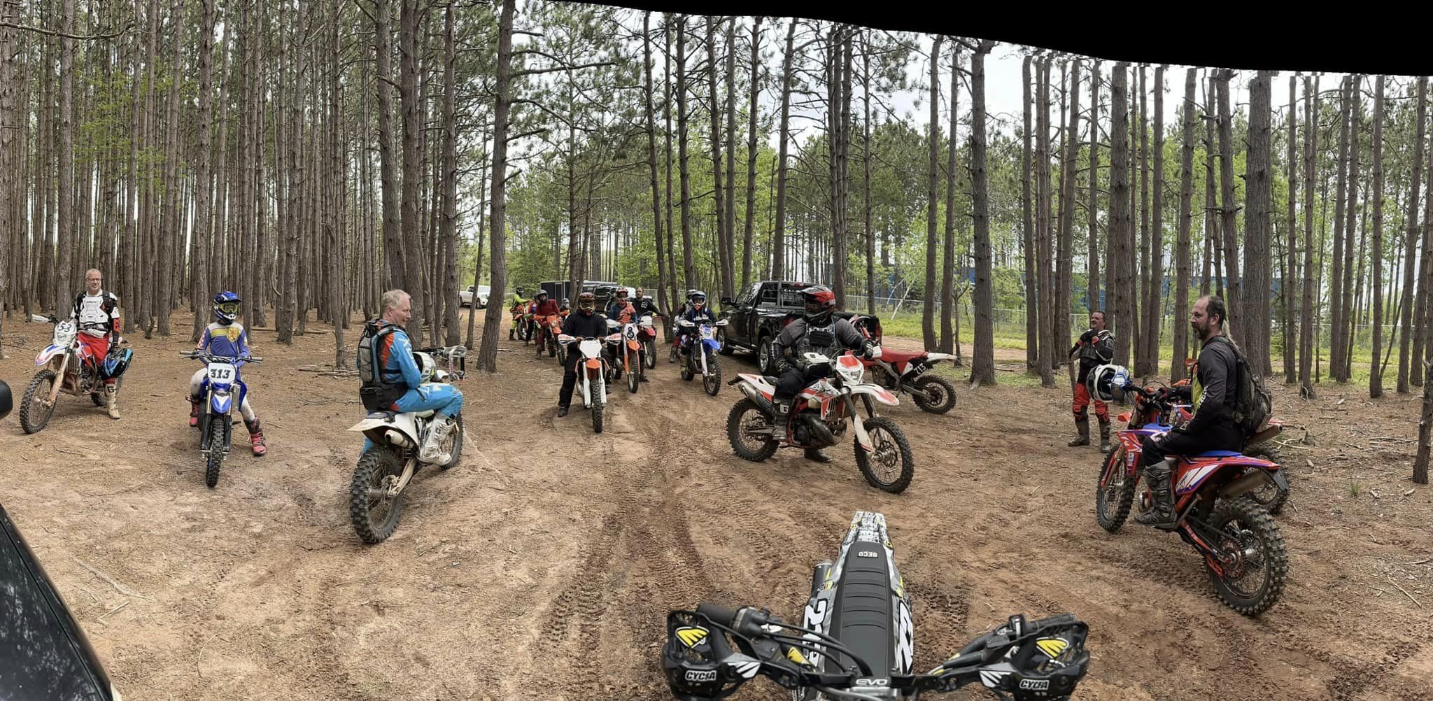 Dirt bike riders in gear getting ready to enter the woods at Debert for a ride