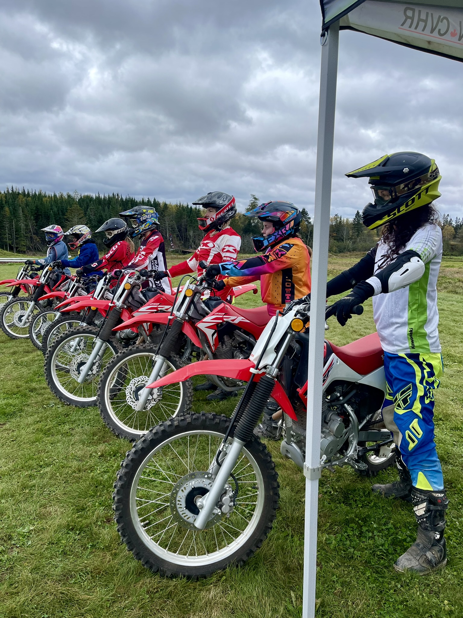 Line up of women on dirt bikes ready for instruction