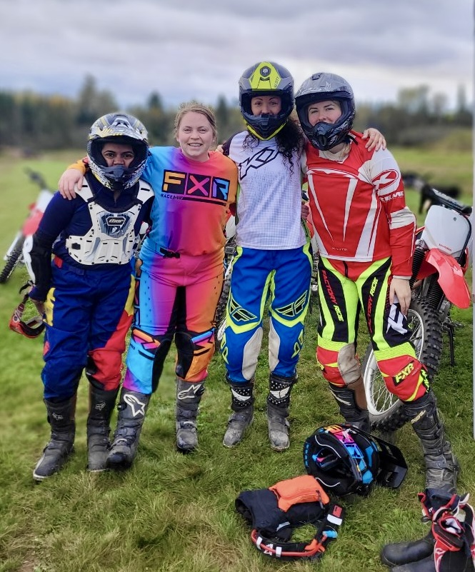 Smiling women in dirt bike gear