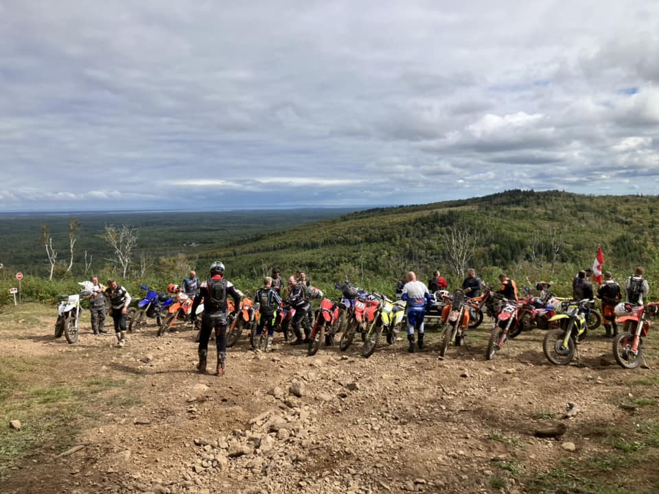 Dirt bike riders at the top of the mountain with their bikes