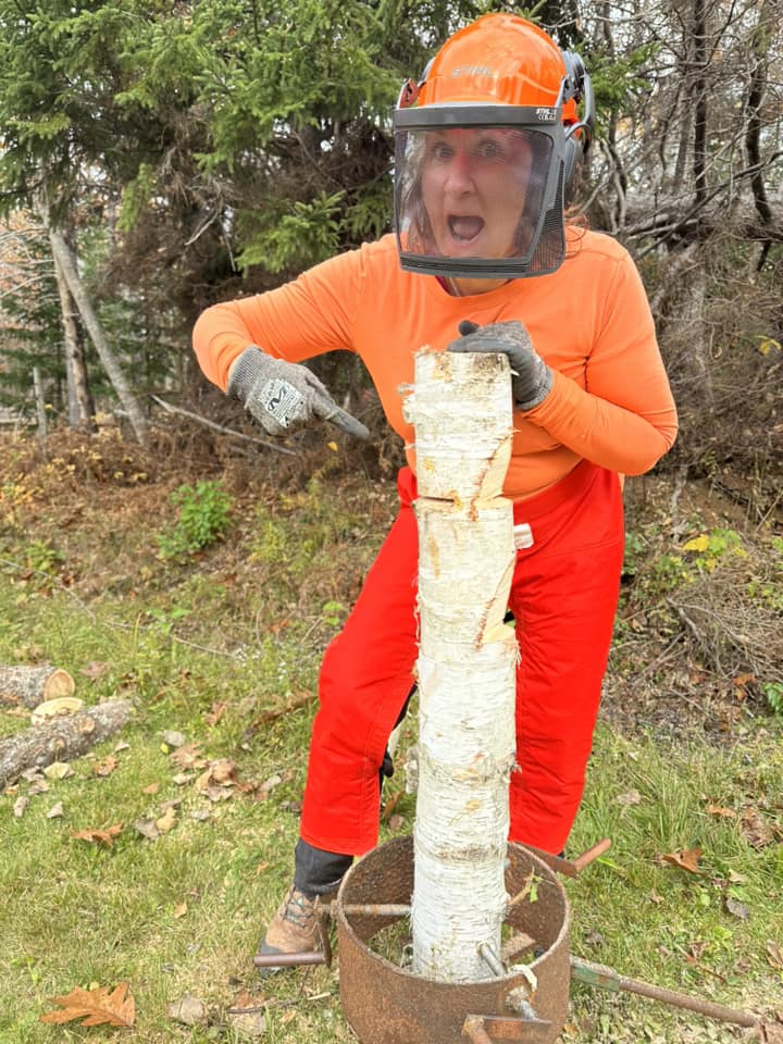 Susan Foote with her log in the holder for chainsaw practice