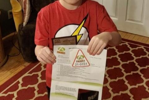 little boy holding an NSORRA membership