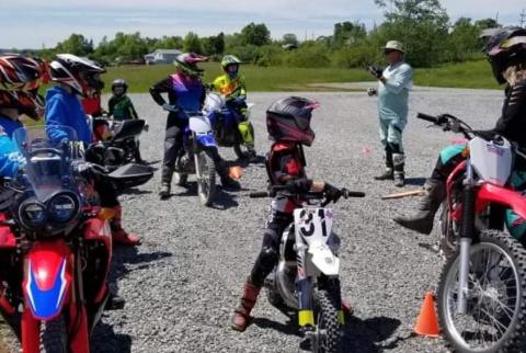 Group of dirt bike riders in full gear on their bikes