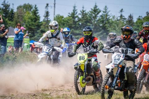 Dirt bike race start with lots of riders