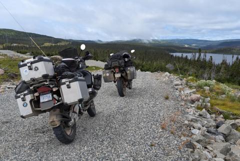 several adventure bikes set up on a gravel path